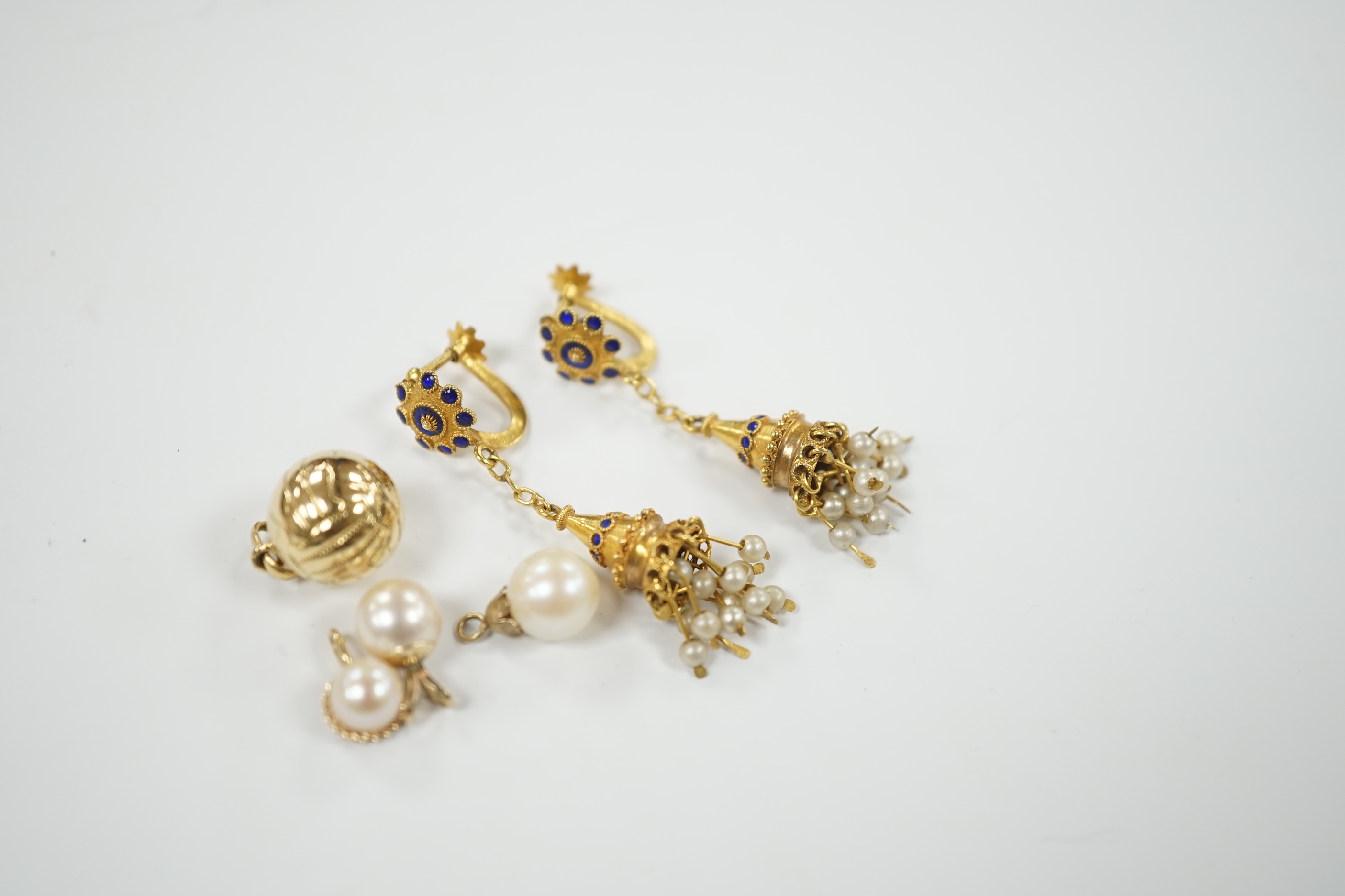 A pair of 585 tassel drop ear clips, 42mm, a yellow metal ball charm and three cultured pearl set pendants.